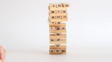 Kadın ve erkek beyaz arka planda jenga oynuyor. Aile eğlencesi ve tatil konsepti.