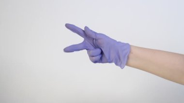 Beyaz arka plandaki mavi eldiven farklı jestleri gösterir: başparmak yukarı, baş parmak aşağı, tamam, bir, iki, üç, beş, yumruk