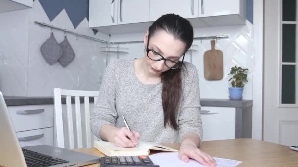 Young woman feeling stressed and upset by high taxes, bills or mortgage rate. Calculating household payments. Accountant works from home calculating bank debt invoice. — Stock Video