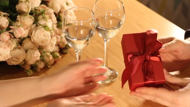 Man Gives Red Present Box Ribbon Woman Indoors Restaurant Home — Stock Video