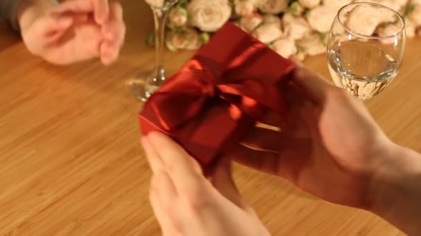 Man Gives Red Present Box Ribbon Woman Indoors Restaurant Home — Stock Video