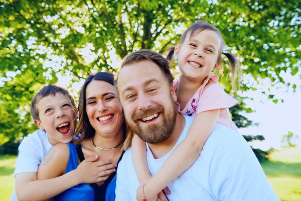 Porträt glücklicher Eltern mit zwei kleinen Kindern — Stockfoto