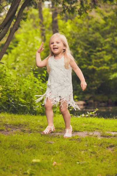 Portrait of happy little girl in summer forest — Stock Photo, Image