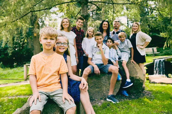 Happy little sister and brother with big family — Stock Photo, Image