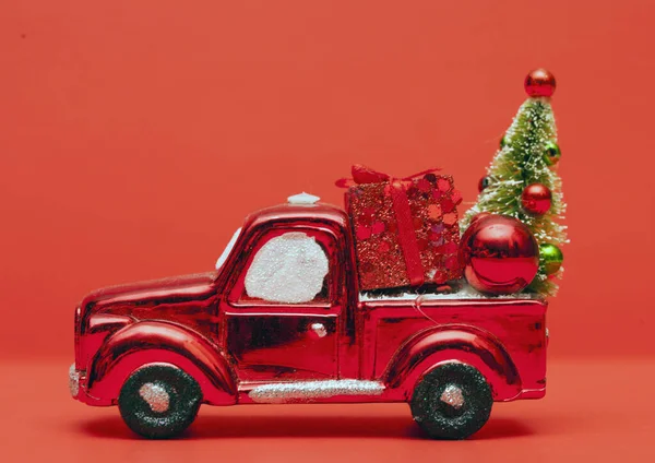 Red toy truck with gift box, bauble and Christmas tree — Stock Photo, Image
