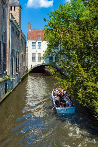 BRUGES, BÉLGICA - 6 de abril de 2008: Turistas flutuam em um barco através — Fotografia de Stock