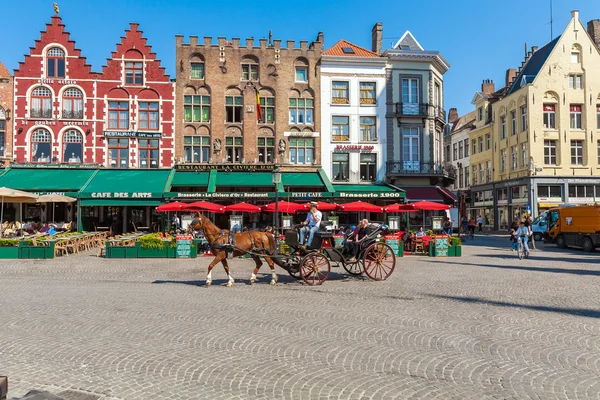 BRUGES, BELGIUM - APRIL 6, 2008: Tourists ride on the Grote Mark — Stock Photo, Image