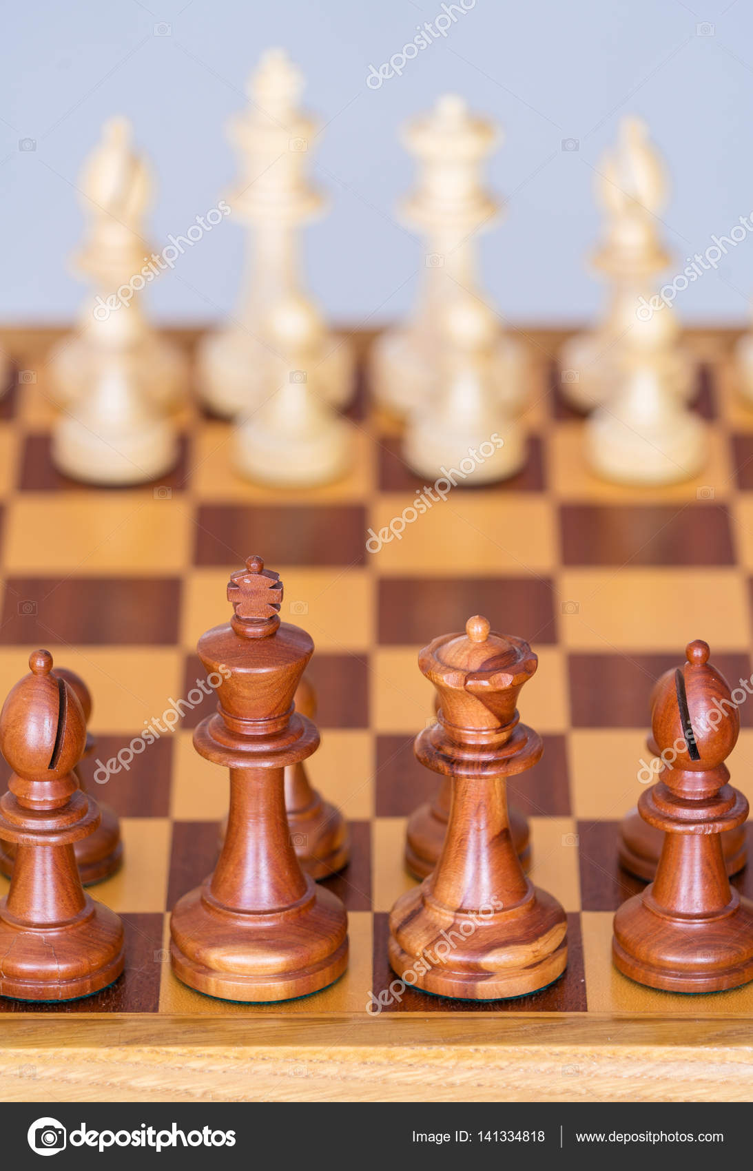 Chess pieces in starting position on a wooden Board Stock Photo by  ©Rostislavv 141334490