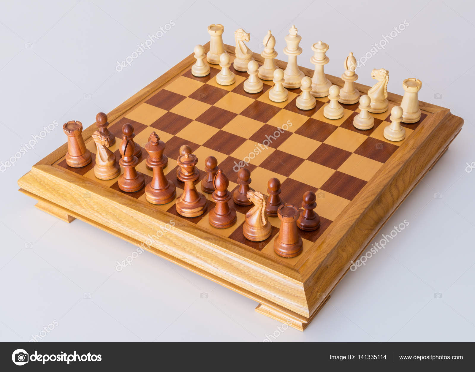 Chess pieces in starting position on a wooden Board Stock Photo by  ©Rostislavv 141334490