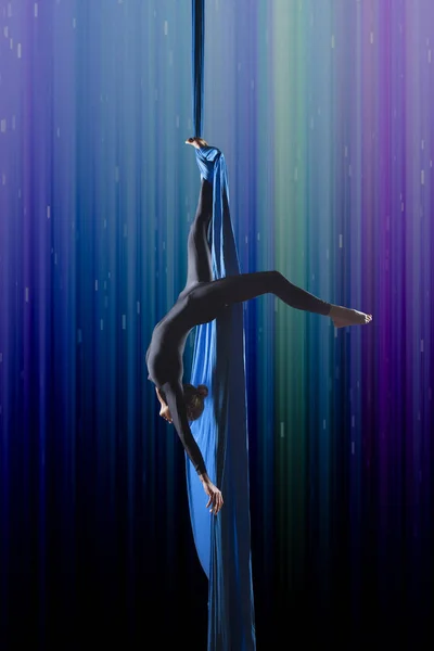 Beautiful woman dancing with aerial silk Stock Photo