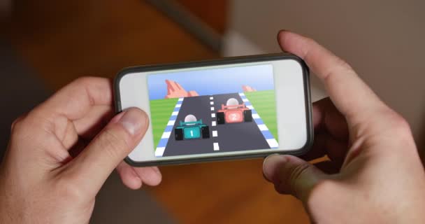 Man Plays Retro 8-Bit Racing Video Game on Smartphone — Stock Video