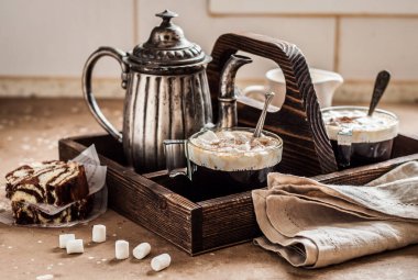 Marshmallowlu kahve ve Mutfak Masasında Tahta Tepside Zebra Pastası Dilimleri