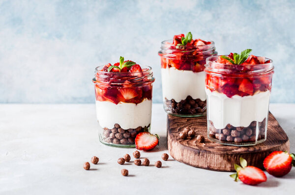 Greek Yoghurt with Strawberries, Honey  and Cereal in Jars, copy space for your text