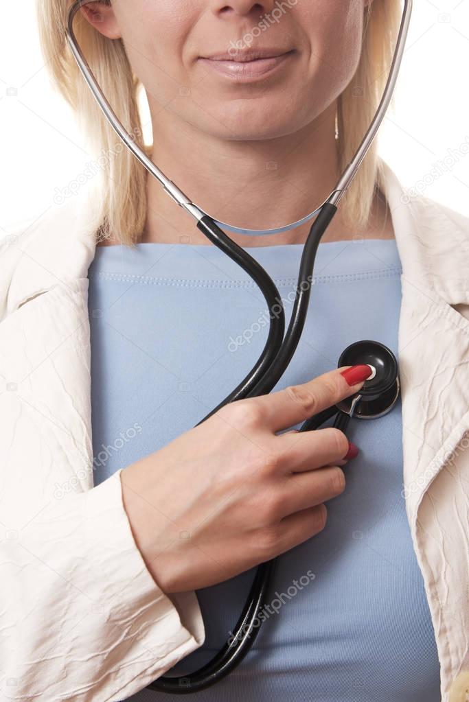 woman using a stethoscope on herself vertical