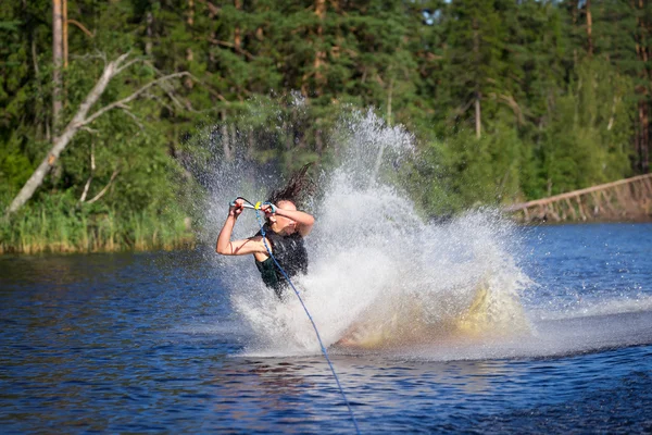 Brunette woman riding wakeboard in a summer lake — Stock Photo, Image