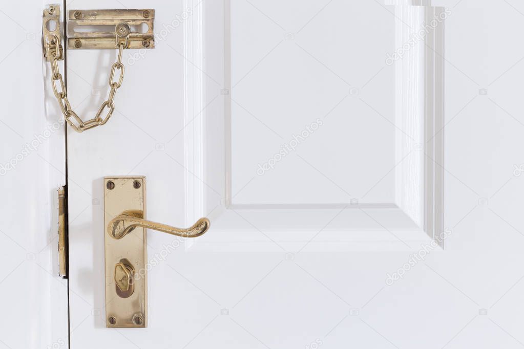 handle and chain on the white front door