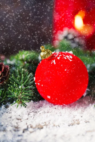 Red Christmas bauble with snow on wood — Stock Photo, Image