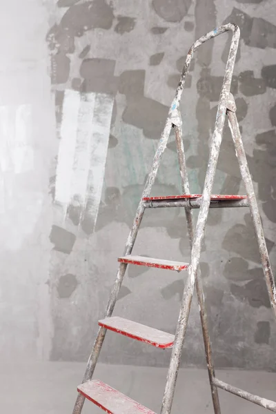 Old painted and stucco ladder on concrete wall