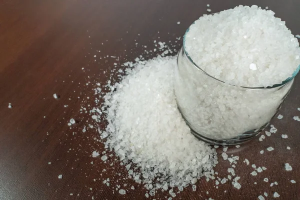 White Crystalline Salt Transparent Glass Jar Scattered Brown Table — Stock Photo, Image