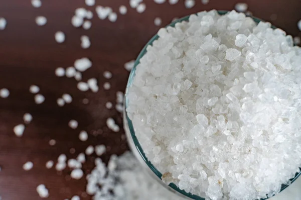 Vitt Kristallint Salt Genomskinlig Glasburk Utspridd Ett Brunt Bord — Stockfoto