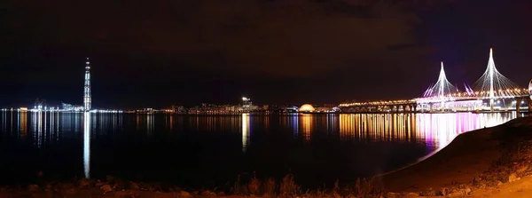 五彩斑斓的全景夜景，河上有灯火通明的桥 — 图库照片