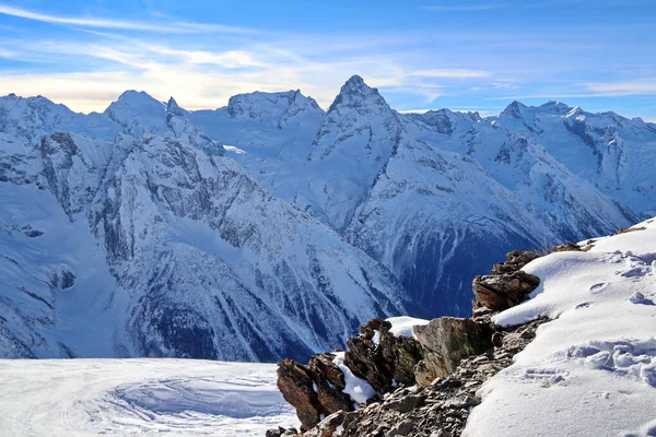 Snowy Mountains peaks in the clouds blue sky Caucasus — Stock Photo, Image