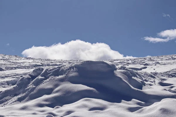 Karlı dağ yamacı ve derin mavi gökyüzü