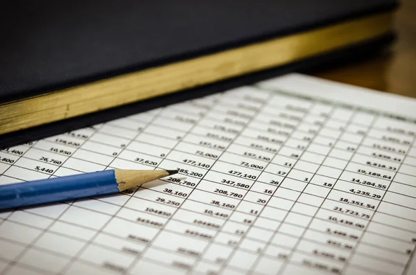 Financial data table and book — Stock Photo, Image