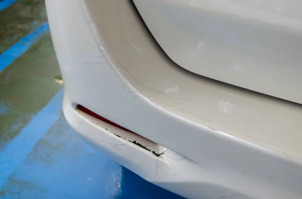 White car rear bumper cracks