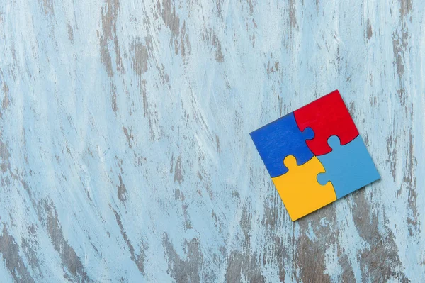 Colorfull puzzles piece on blue background. World Autism Awareness Day Concept