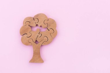 Pembe arka planda tahta ağaç yapbozu