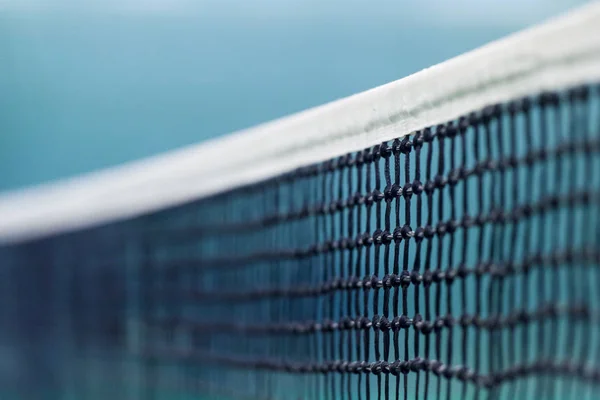 Tennis net and blue court. Individual sport