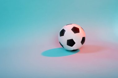 Mavi neon arkaplanda izole edilmiş futbol topu