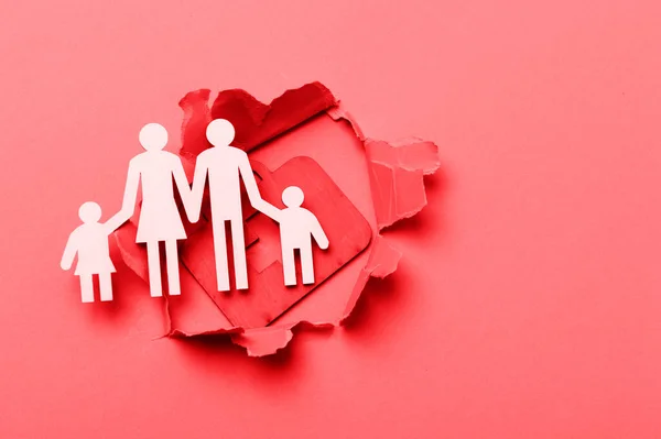 Yardım Çantası Tabelası Kağıt Kesiği Olan Bir Aile Kırmızı Arkaplan — Stok fotoğraf
