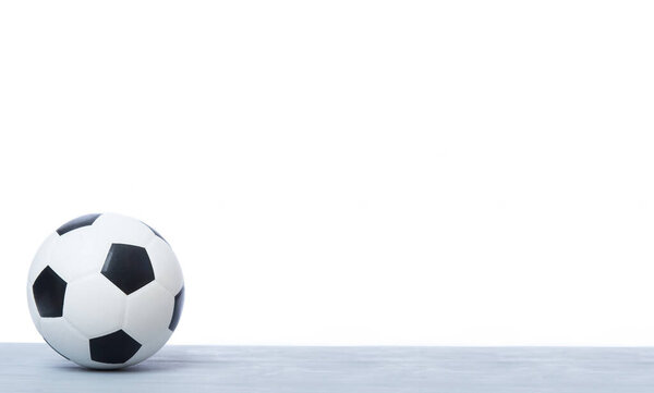 Soccer ball or football on grey wooden floor. Online workout concept