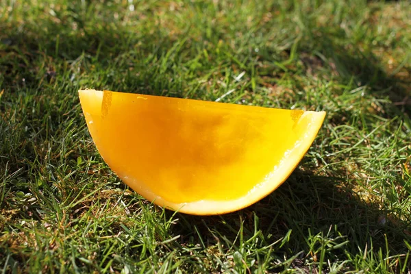 Jelly gummy galia melon yellow orange fruit on grass