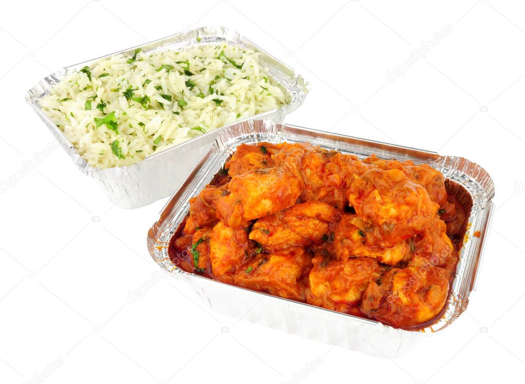 Chicken curry take away meal with rice in foil containers isolated on a white background