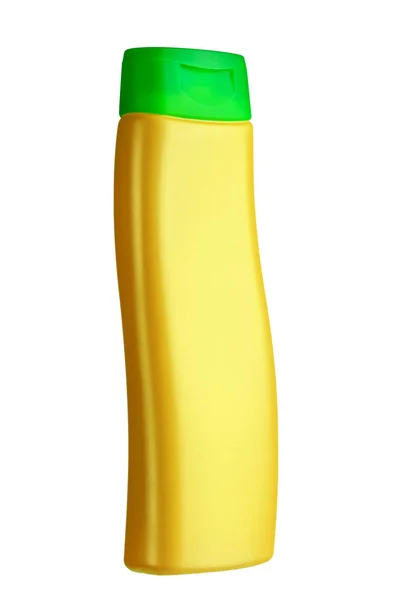 Plastikflaschen-Shampoo gelber Farbe mit grünem Deckel. — Stockfoto