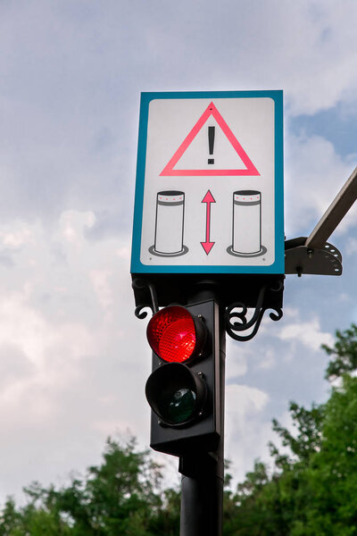 Traffic light with warning sign.