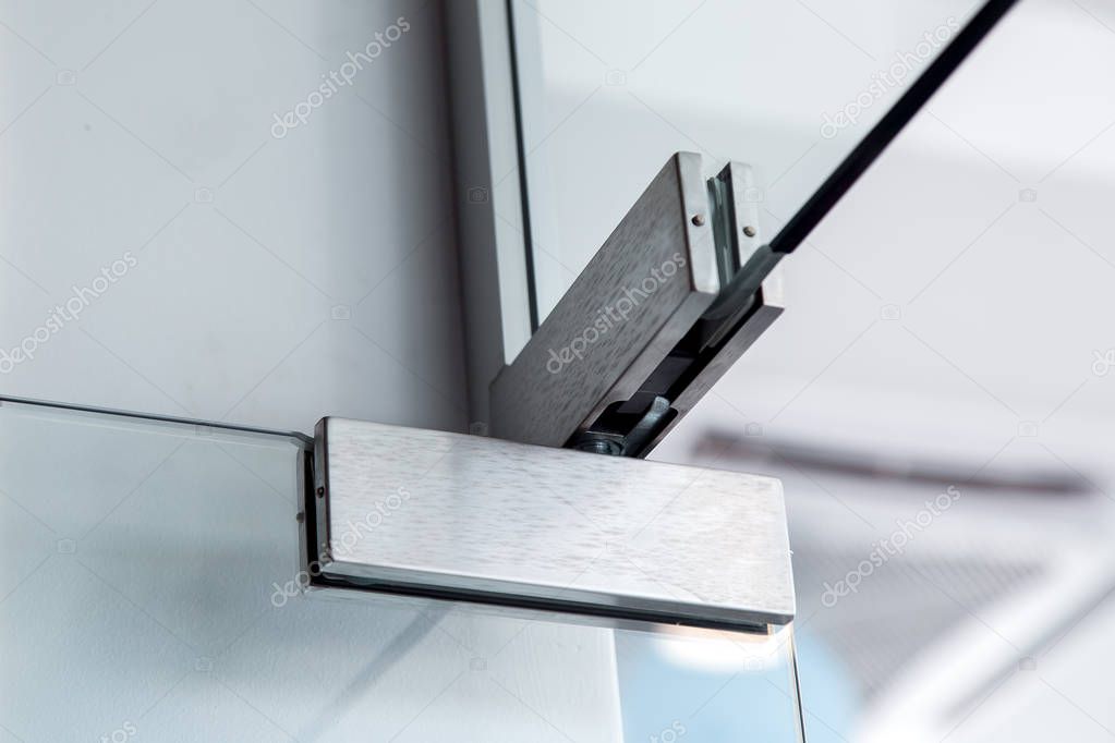 glass door hinges, close up of hinged accessories of transparent partitions.