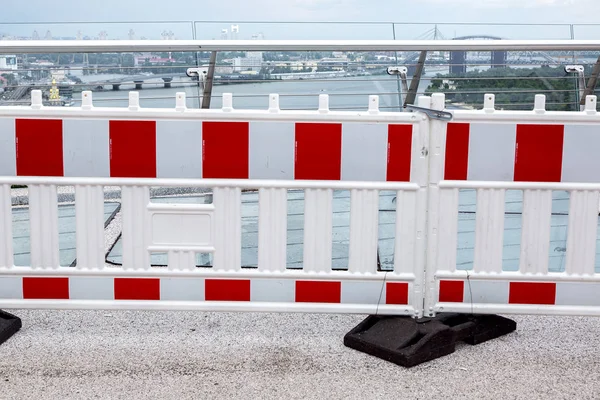 a hazardous area fencing barrier on a pedestrian bridge with a glass edge, nobody.