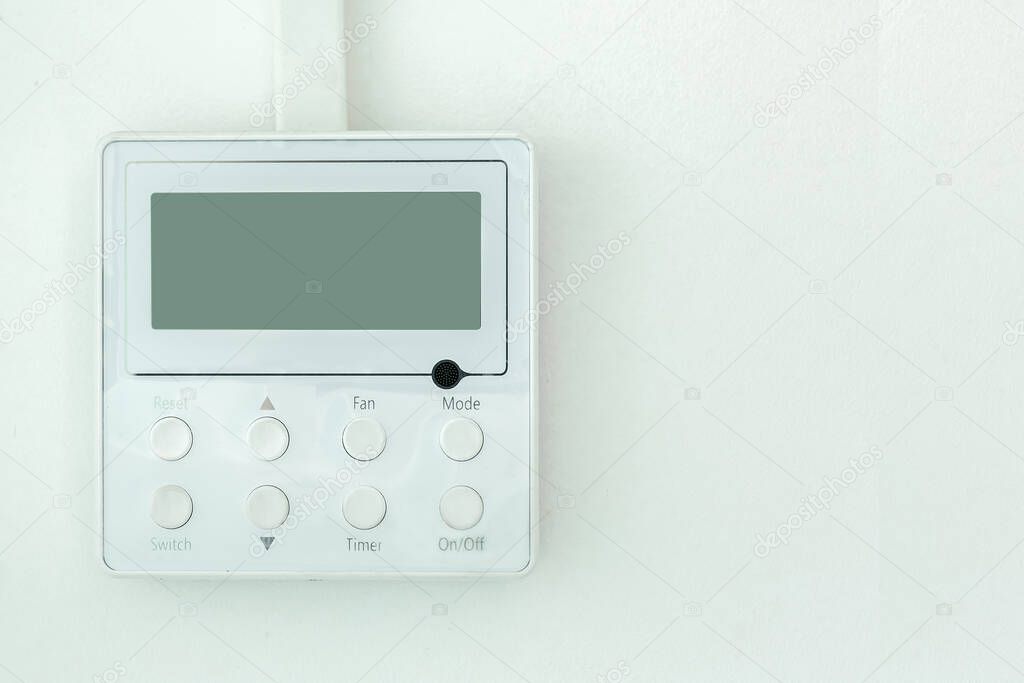 white wall air conditioning control panel with screen and control buttons with copy space close up.