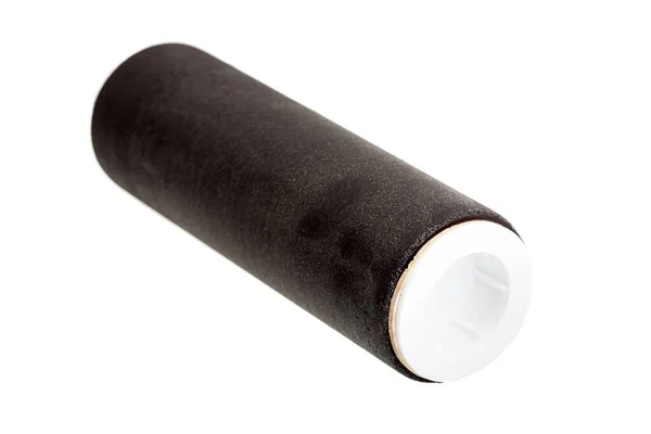 filter for cleaning and reducing the salt content in drinking water, a black replacement cartridge lies on its side isolated on a white background.