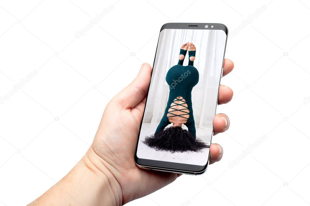 remote online yoga class gadget broadcasting communication of the trainer with quarantined people sitting at home on the phone, telephone hold on hand isolated on white with a woman on the screen.