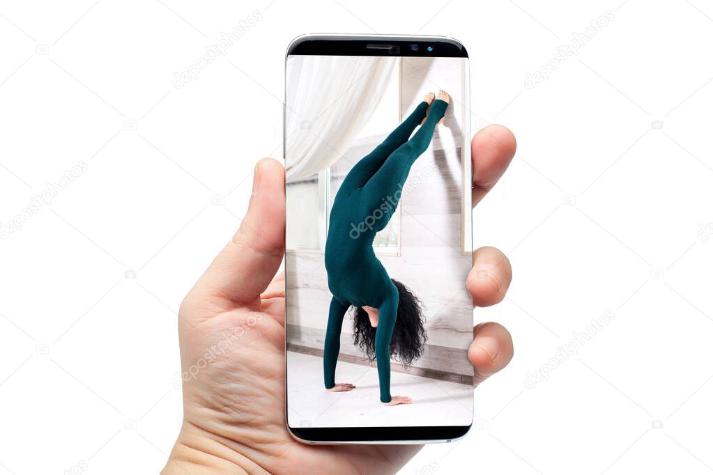 remote online yoga class gadget broadcasting communication of the trainer with quarantined people sitting at home on the phone, telephone hold on hand isolated on white with a woman on the screen.