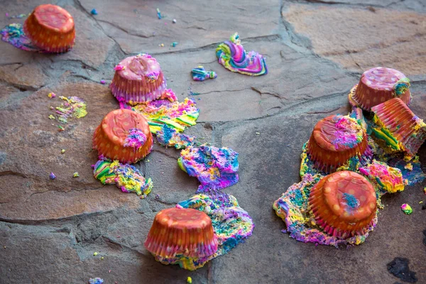 Fresh sweet multi-colored cakes have fallen to a floor, crash of festive pastries.