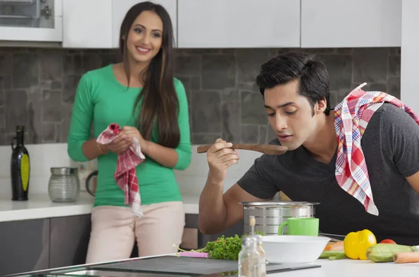 Young man tasting soup — Stock Photo, Image