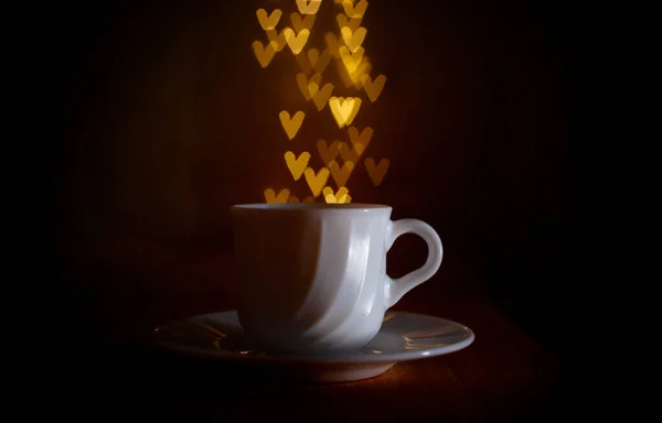 bokeh of hearts in a mug in the dark