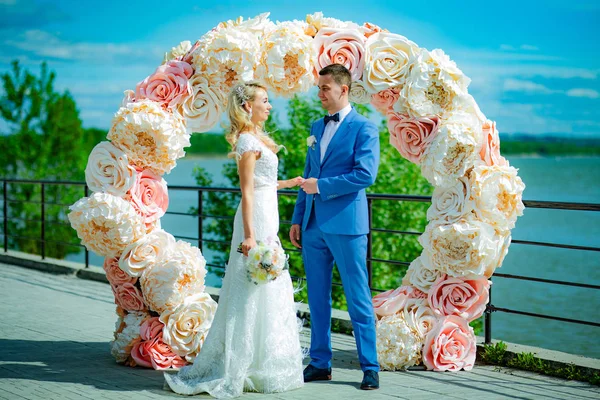 Young beautiful couple of newlyweds bride and groom during a wed