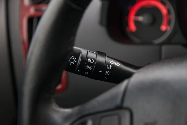 The lever for switching lights and turn signals under the steeri